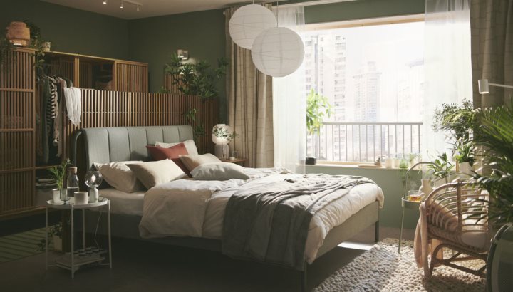 A serene and calm green bedroom that feels close to nature